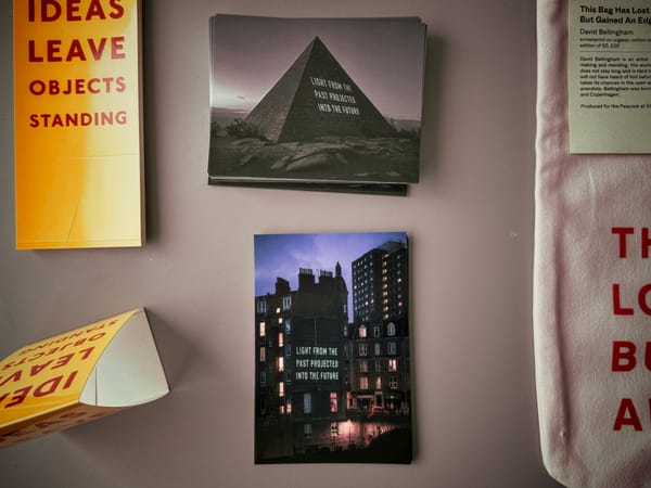 My postcard is of a building with ‘LIGHT FROM THE PAST PROJECTED INTO THE FUTURE’ projected against it